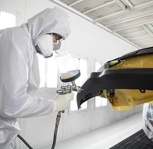 Collision Center Technician Painting a Vehicle | Toyota of Laramie in Laramie WY
